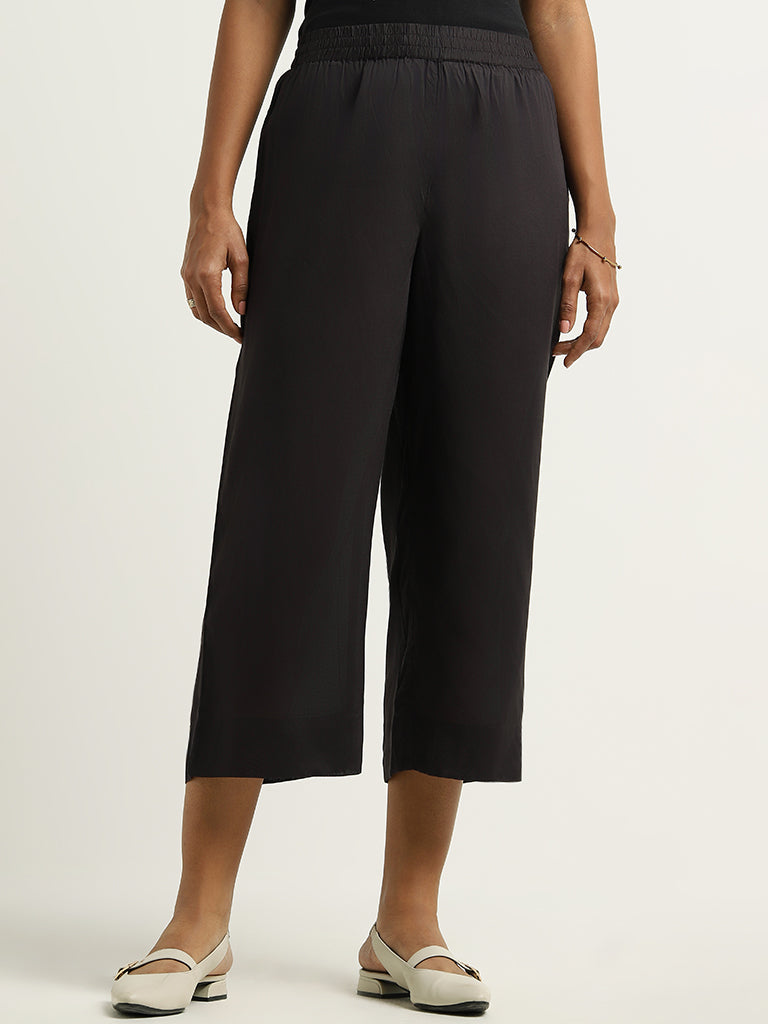 Buy Gia Solid Black Mid Rise Wide Leg Trousers from Westside