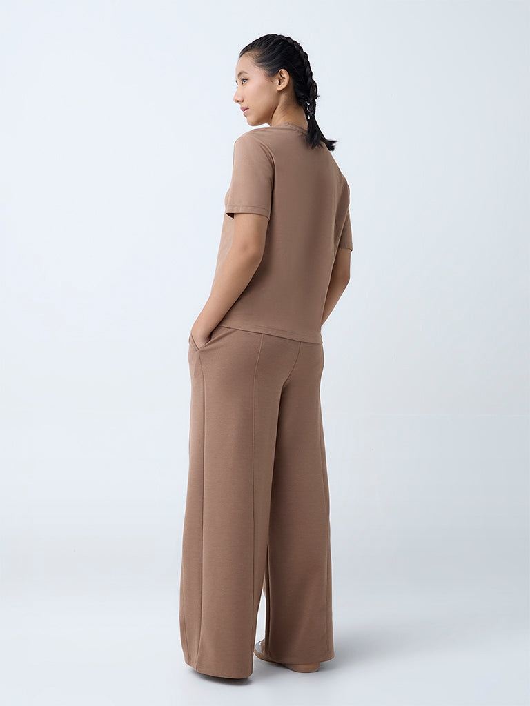 Westside Studiofit Women's Brown Solid High-Rise Track Pants for Sports Wear Back View