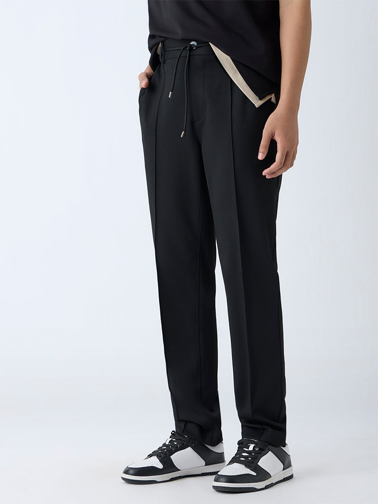Westside Studiofit Men's Black Solid Relaxed-Fit Mid-Rise Pants for Sports Wear Front View