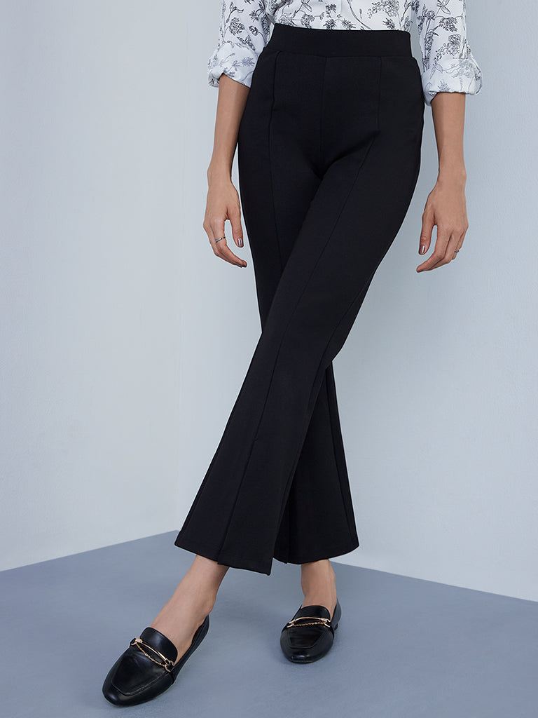 Black faux leather bootleg trousers | River Island