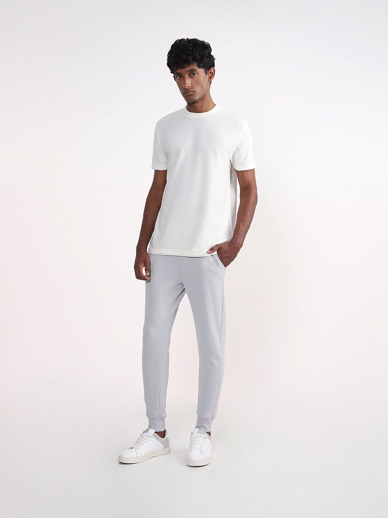 Premium AI Image  A man wearing a white shirt and white pants stands on a  bridge